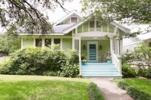 sage green house with black trim